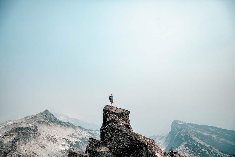 person standing on top of mountain